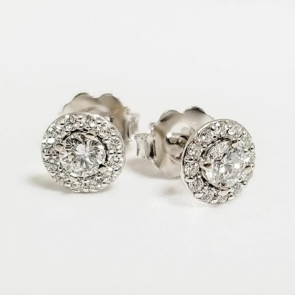A pair of white gold diamond stud earrings.