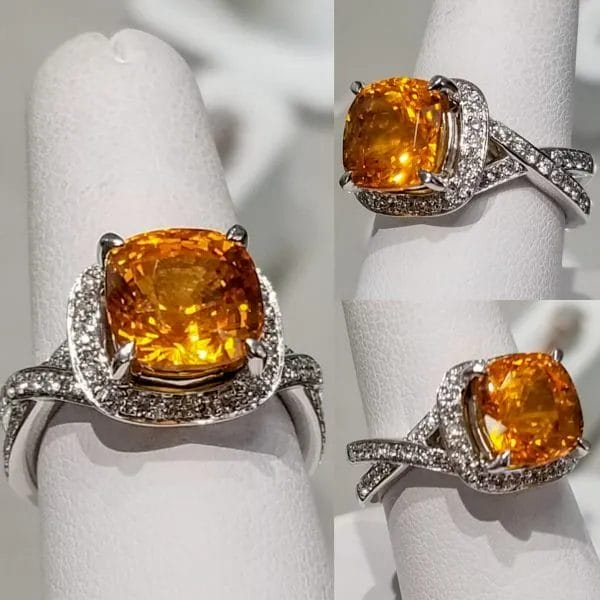 A ring with an orange sapphire and diamonds.