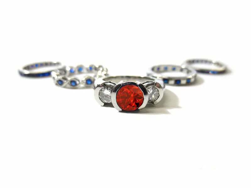 A set of rings with red and blue stones.