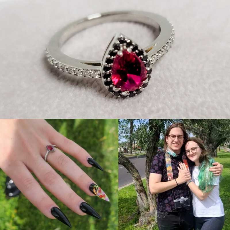 An engagement ring with a pink stone and black nails.