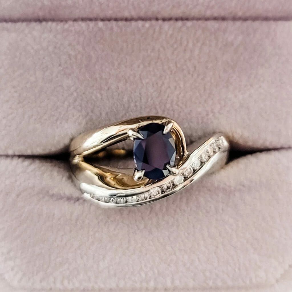 A sapphire and diamond ring in a box.