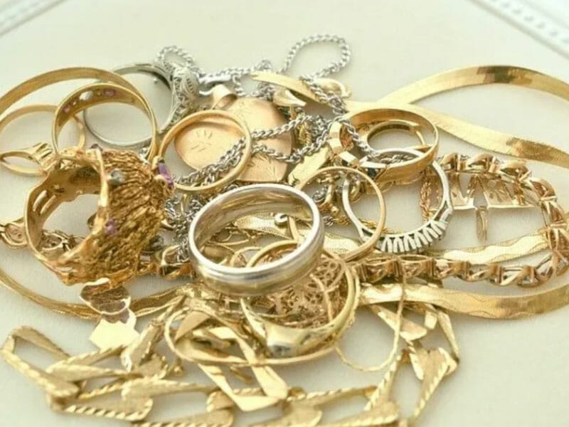 A pile of gold jewelry on a table.