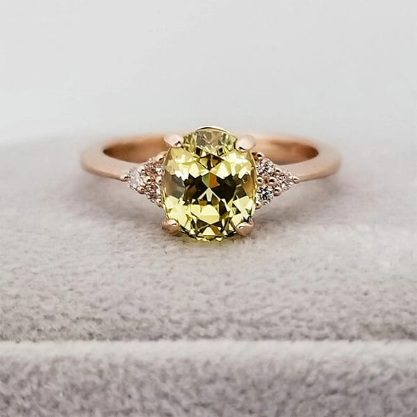 A yellow sapphire and diamond engagement ring.