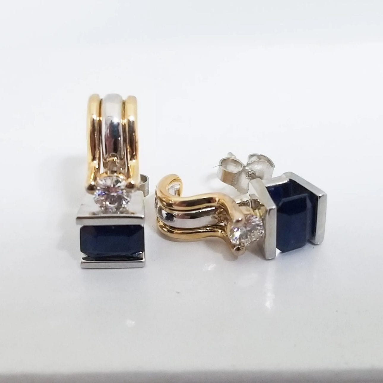A pair of blue sapphire and white gold earrings.
