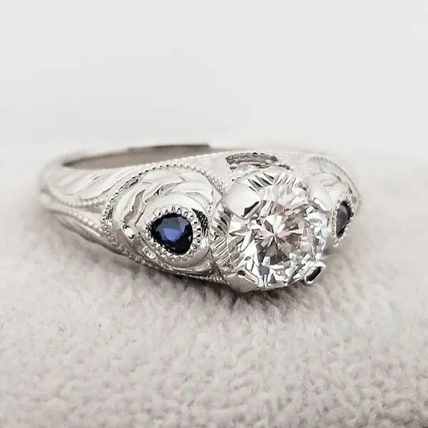 A white gold engagement ring with sapphires and diamonds.