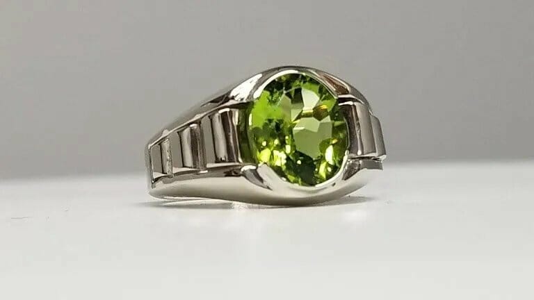 A sterling silver ring with a peridot stone.