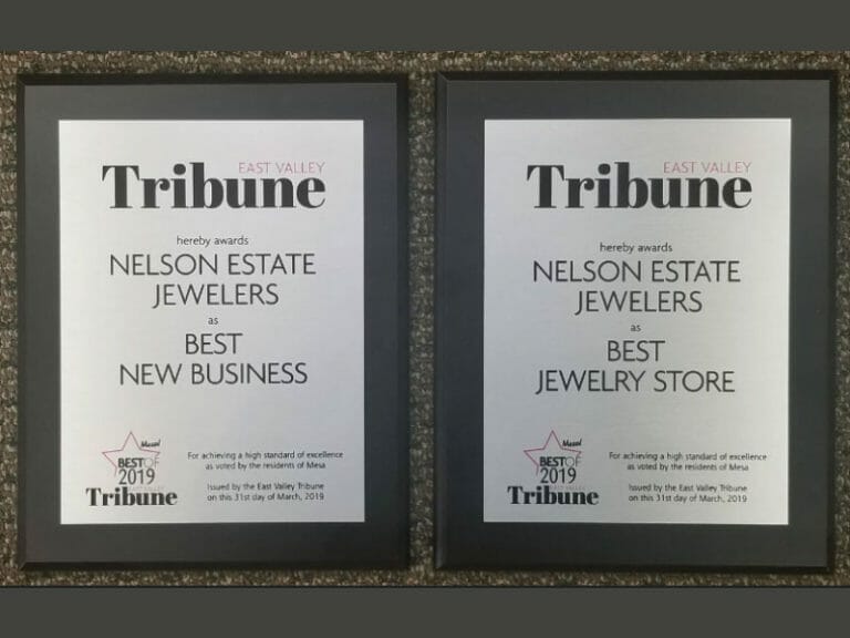 Two framed plaques with the words tribune best new jewelry store.