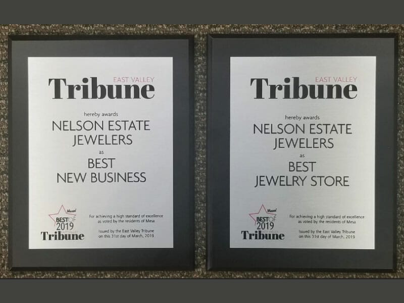 Two framed plaques with the words tribune best new jewelry store.