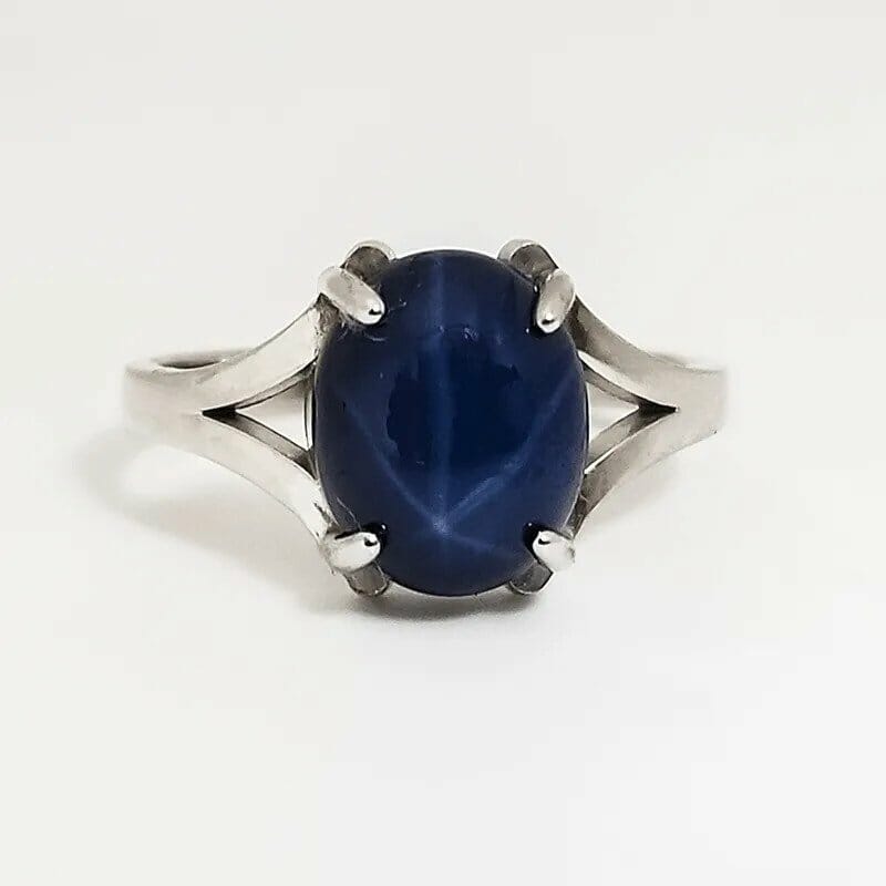 A sterling silver ring with a blue stone.