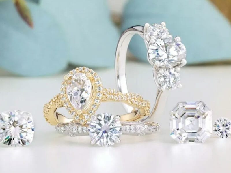 A variety of diamond engagement rings on a table.