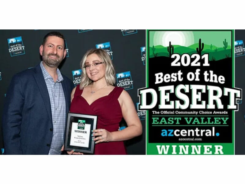 A man and woman holding an award for best of the desert.