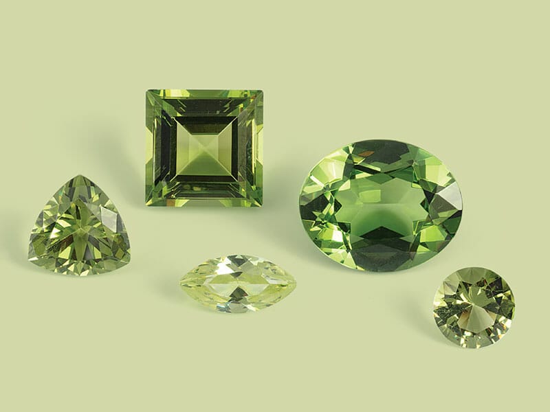 A group of green gemstones on a green background.