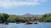 A group of people on rafts on a river.