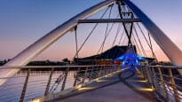 A bridge over a body of water at dusk.