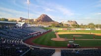 Tempe Diablo Stadium with empty seats and a mountain in the background.