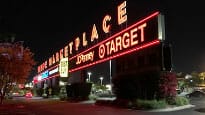 A sign that says target market place at night.