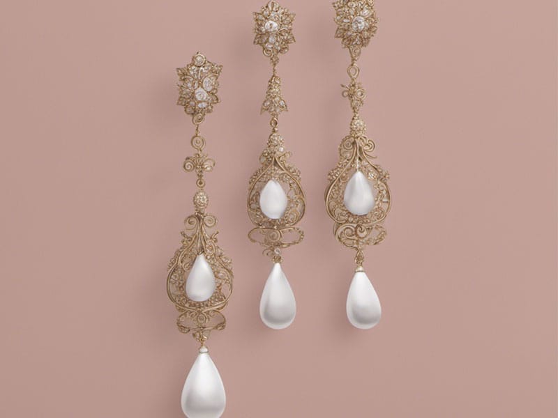 Three gold and pearl drop style earrings on a pink background.