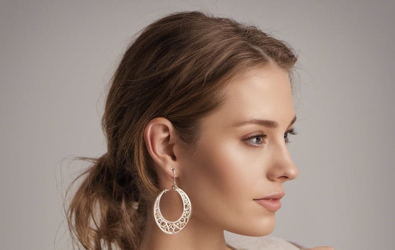 A woman wearing a pair of white hoop earrings.