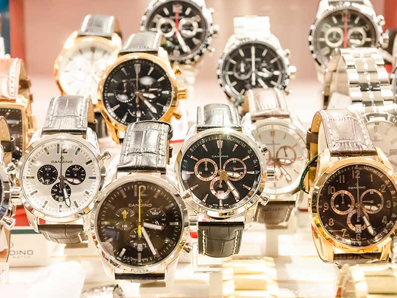 A group of watches on display in a jewelry store.