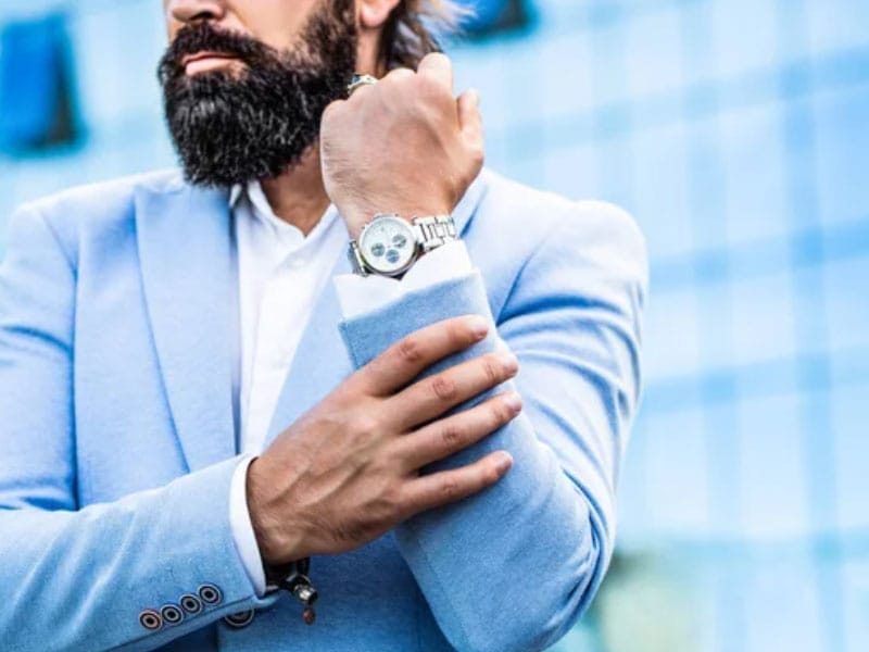 A man with a beard and a fine watch.