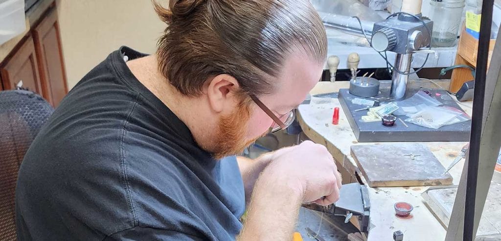 A man working on a piece of jewelry.