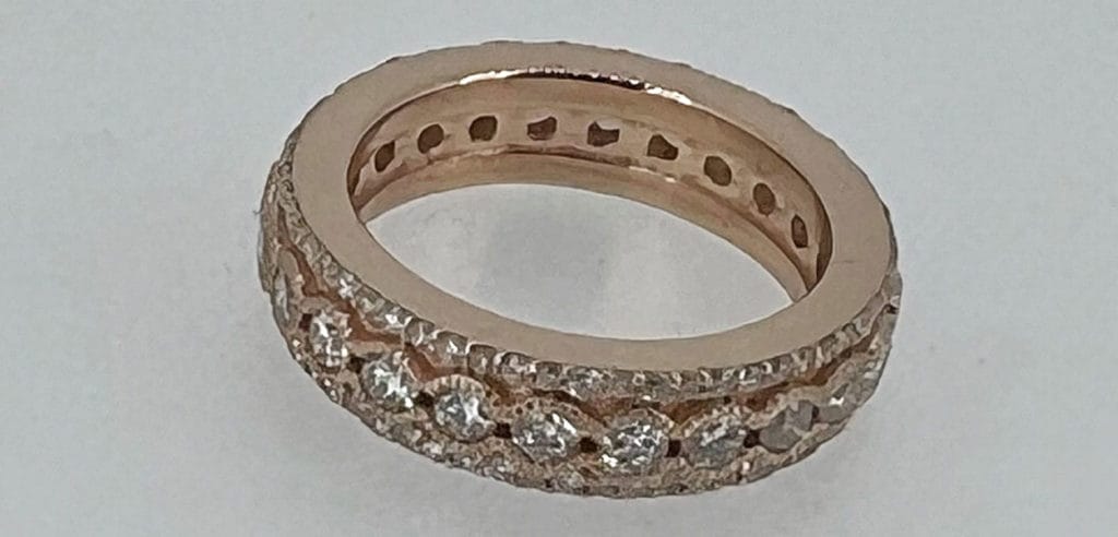 An 18k rose gold diamond eternity ring.